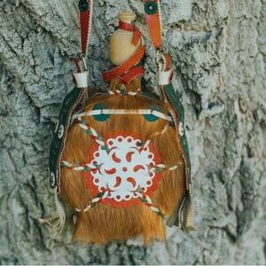 Handmade water flask with fur and leather details